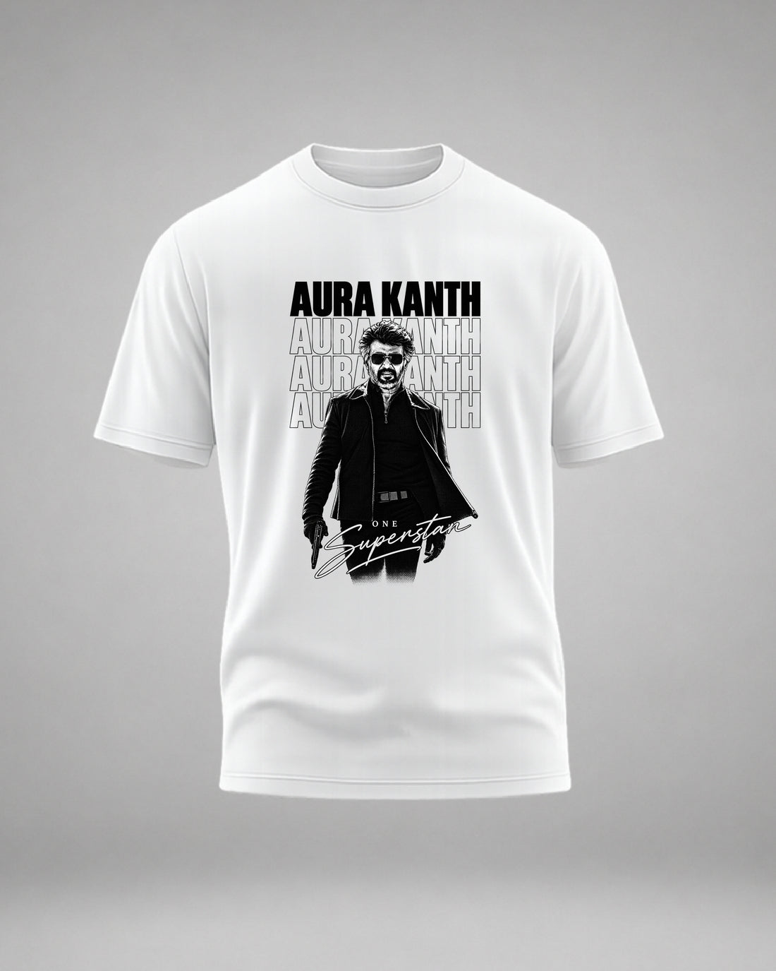 A man wearing a white graphic t-shirt with a black and gray print of a man in sunglasses and the text 'AURA KANTH' and 'The Superstar', against a light gray background.