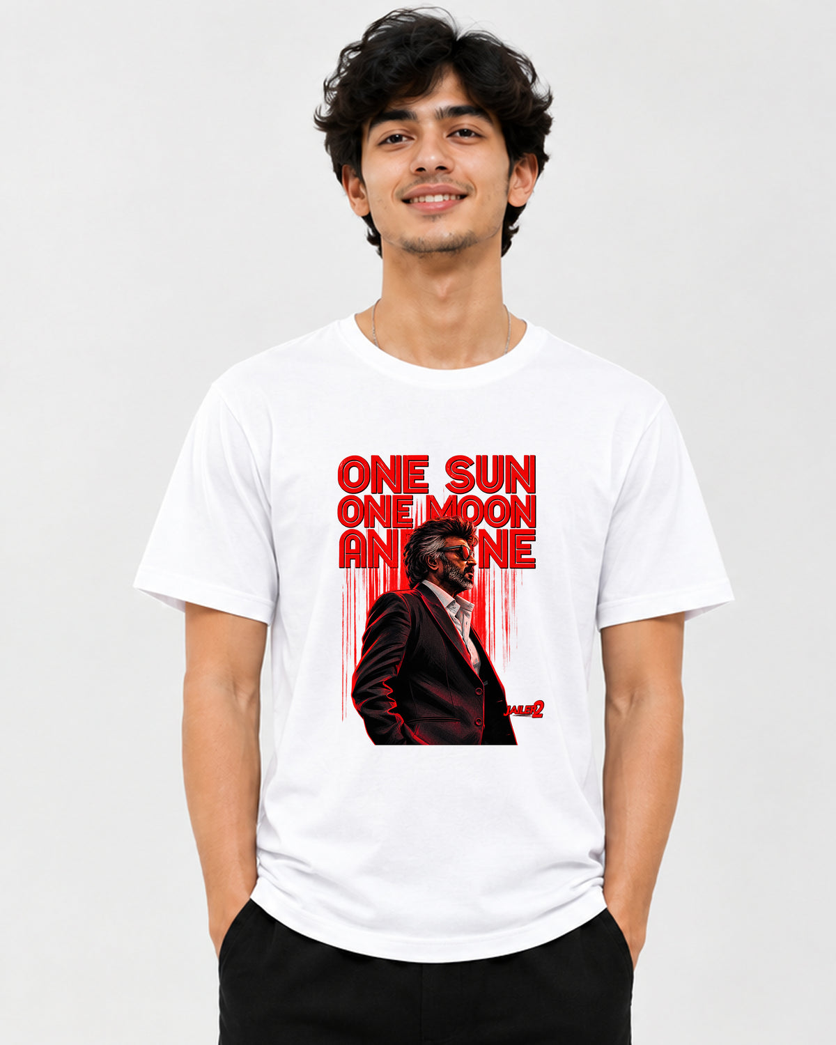 A man wearing a white crewneck t-shirt with a red graphic print on the front. The graphic features the text 'ONE SUN ONE MOON AND ONE' in bold red letters above an illustration of a man in a suit.